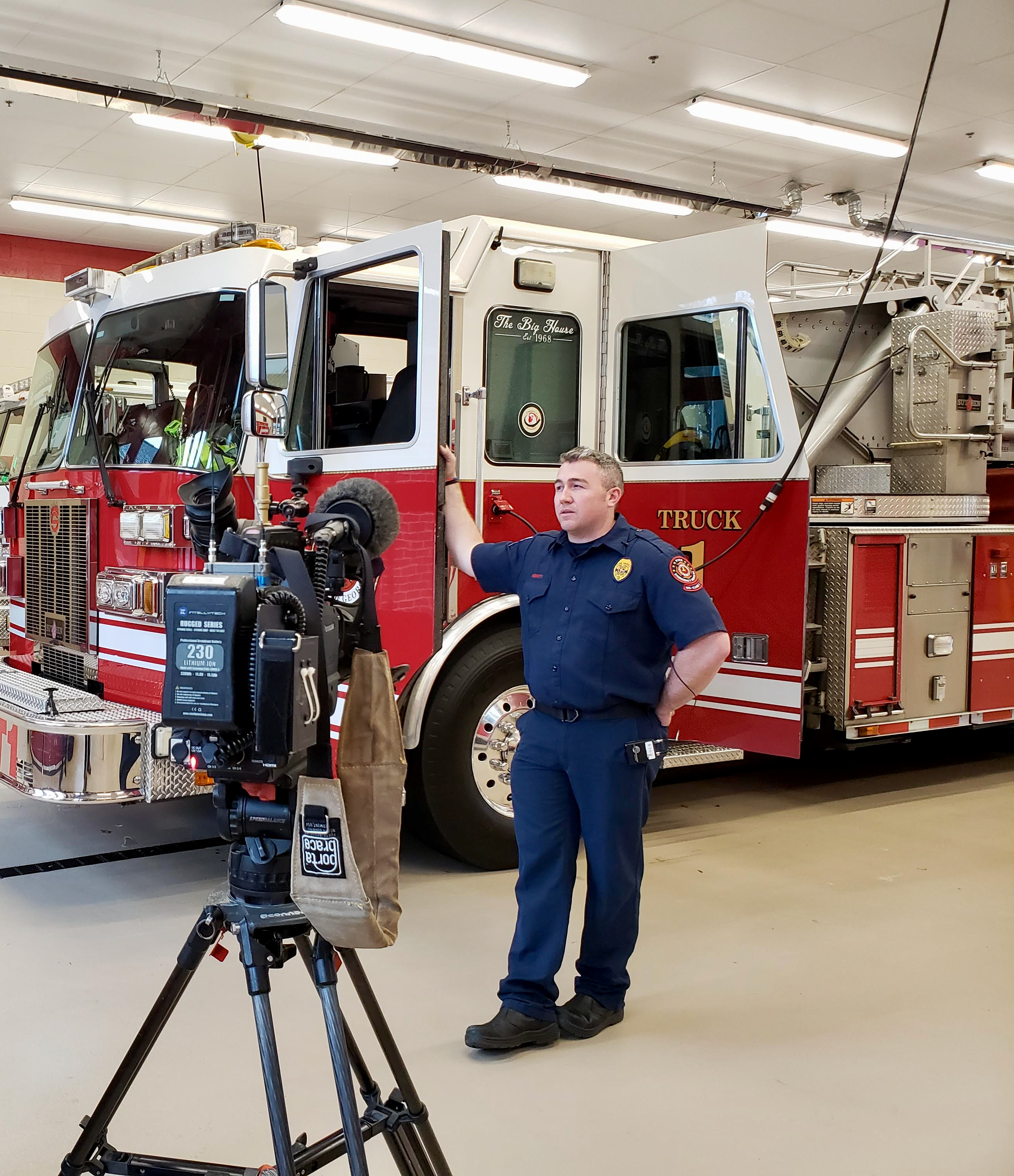 Firefighter in front of fire truck